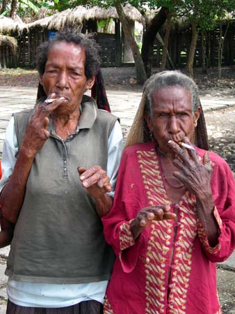 Smoking Papua women with their cut fingers